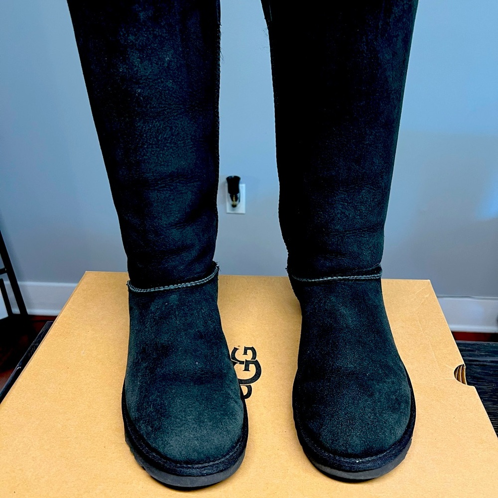 UGG Kristabelle Tall black boots with leather ties in the back.